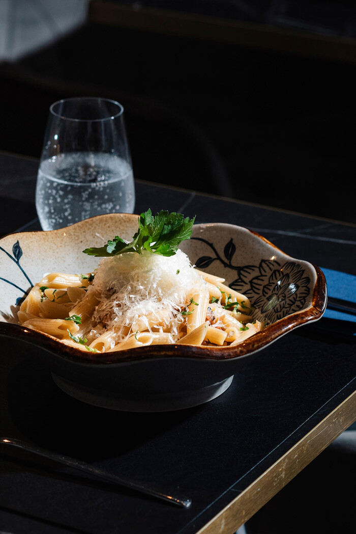 Japanische Udon-Nudeln mit Garnelen und Gemüse in dunkler Schale im Tiger Room